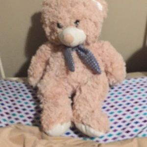 Tan Stuffed teddy bear with blue bow